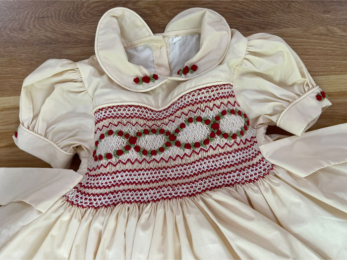 Cream with red smocking